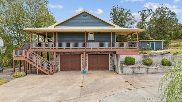 farmhouse featuring a garage and covered porch