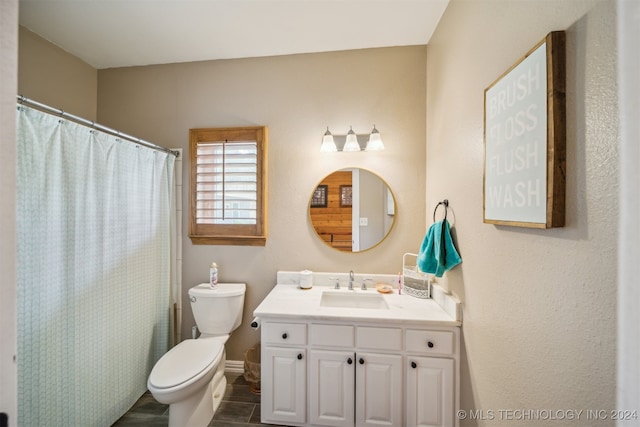 bathroom featuring vanity and toilet