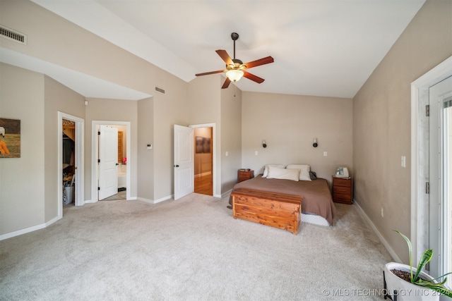 carpeted bedroom featuring ceiling fan, a closet, a spacious closet, ensuite bath, and vaulted ceiling