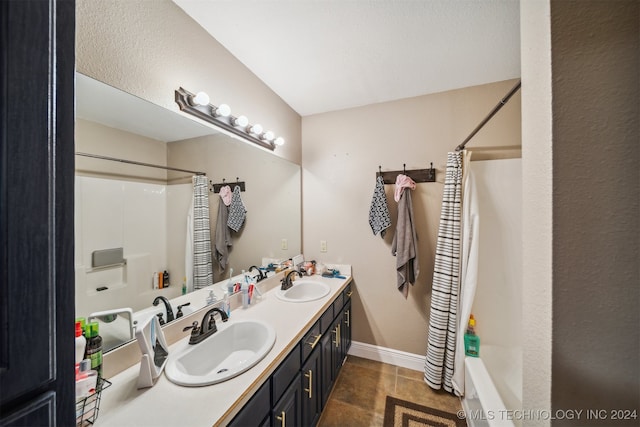 bathroom featuring shower / bath combination with curtain, tile patterned floors, and vanity