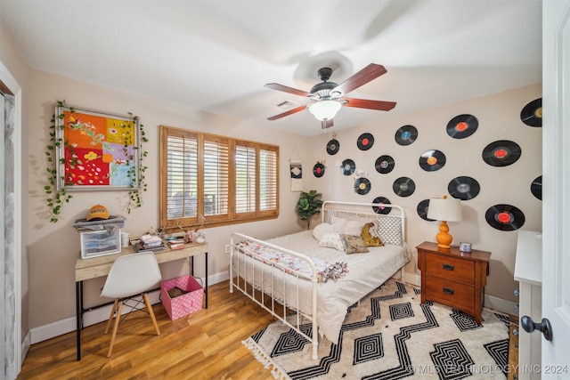 bedroom with light hardwood / wood-style floors and ceiling fan