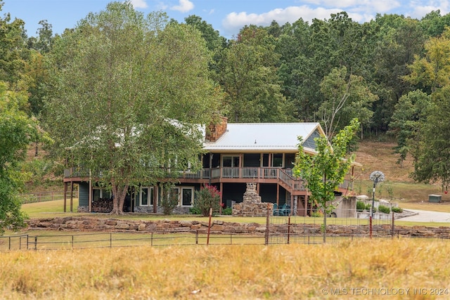 rear view of house featuring a wooden deck