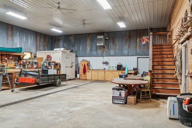 garage with ceiling fan and a workshop area