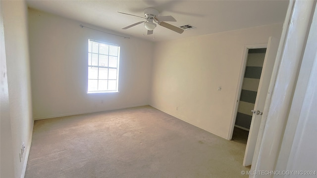 unfurnished room featuring light carpet and ceiling fan