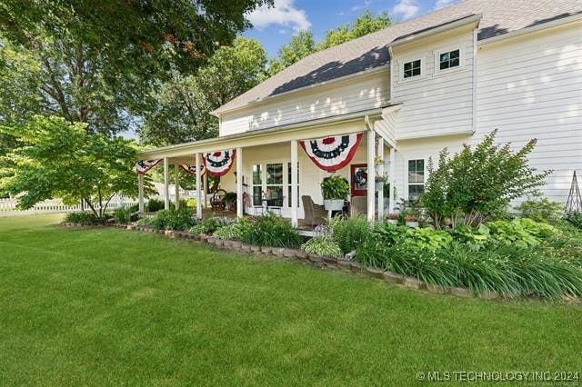 back of property with a yard