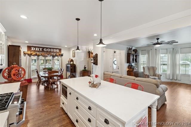 kitchen featuring white cabinetry, dark hardwood / wood-style floors, plenty of natural light, and a kitchen island