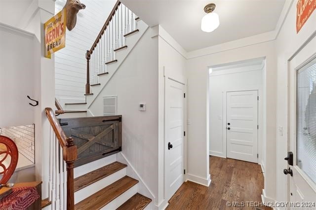 stairs featuring wood-type flooring