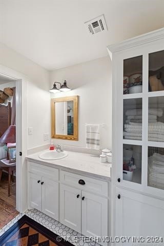 bathroom with hardwood / wood-style floors and vanity