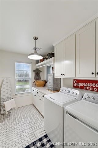 laundry area featuring independent washer and dryer and cabinets