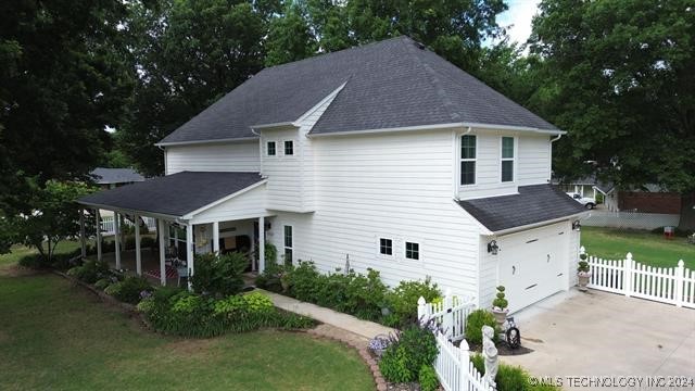 view of front of home with a garage and a front lawn