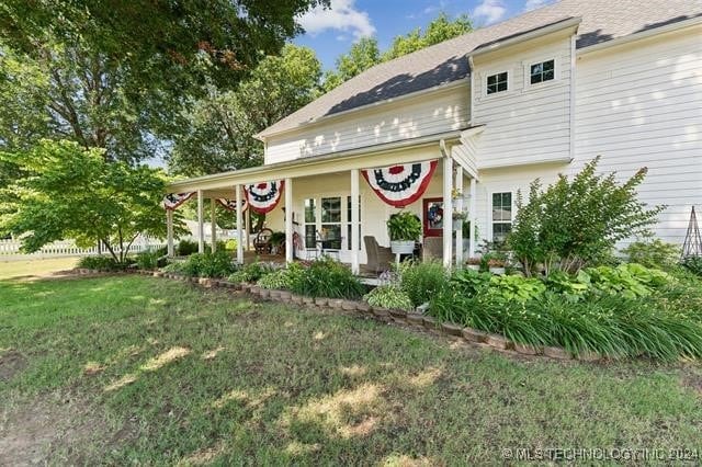 rear view of house with a yard