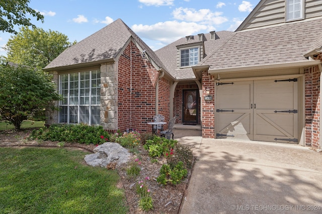 view of front of house with a front yard and a garage