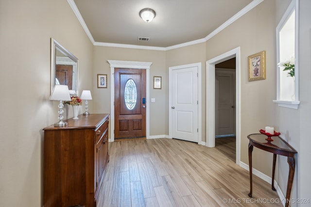 entryway featuring light wood-type flooring and crown molding