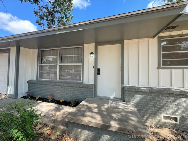 property entrance with a garage