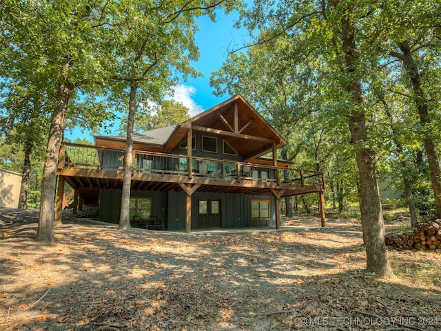 rear view of house with a wooden deck