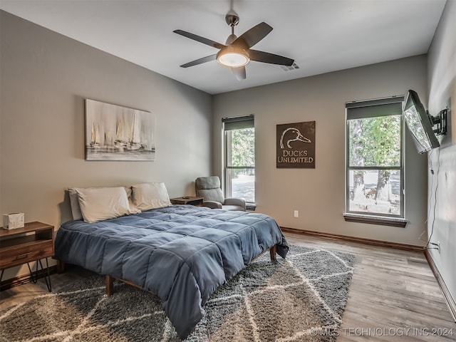 bedroom featuring wood-type flooring and ceiling fan