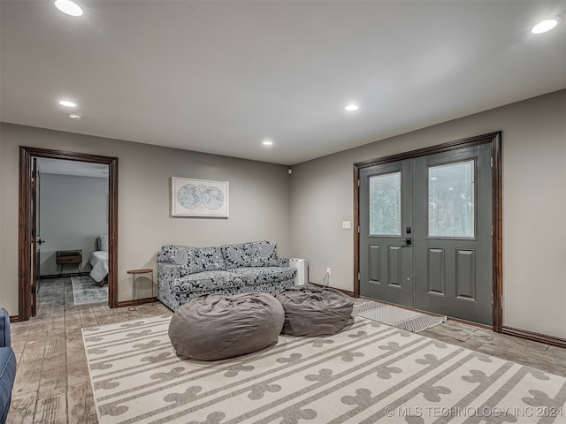 sitting room featuring light wood-type flooring and french doors