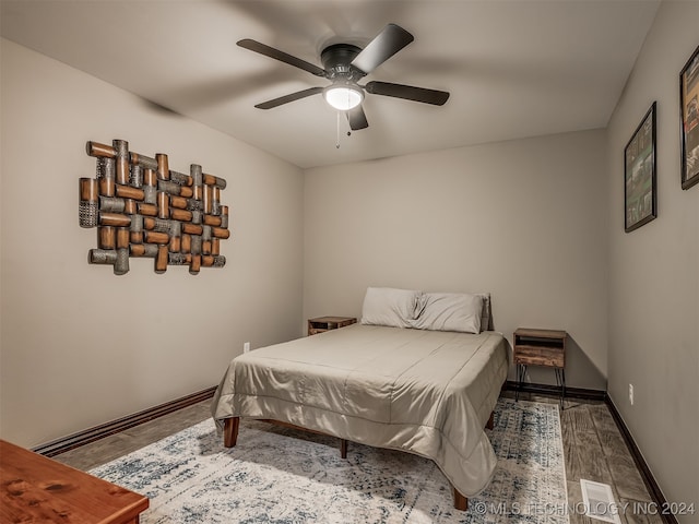 bedroom with ceiling fan and dark hardwood / wood-style floors