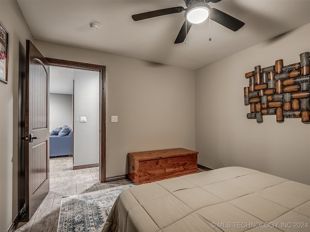 bedroom with ceiling fan and light hardwood / wood-style flooring