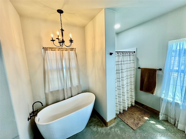 bathroom with a bathtub and a chandelier