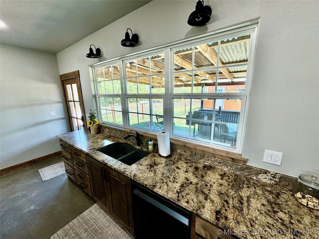 kitchen featuring dark brown cabinets, black dishwasher, stone countertops, and sink