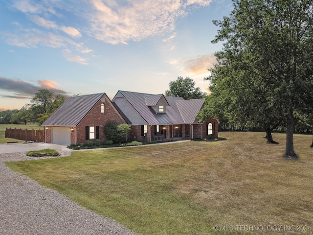 view of front of house with a yard and a garage