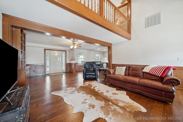 living room with dark hardwood / wood-style flooring and ceiling fan