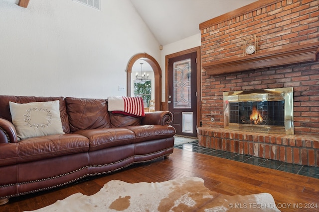 living room featuring a fireplace, dark hardwood / wood-style flooring, and high vaulted ceiling