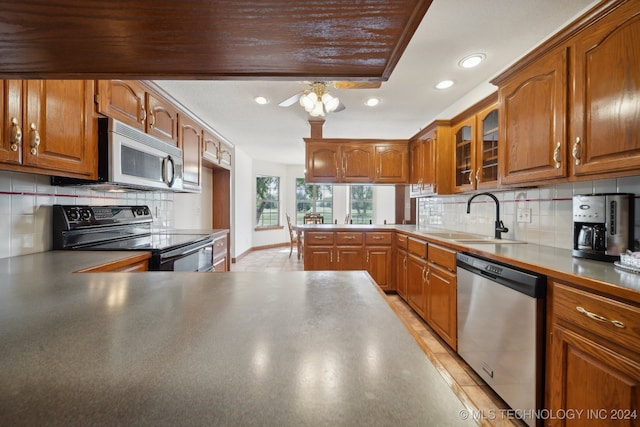 kitchen featuring electric range, dishwasher, kitchen peninsula, and sink