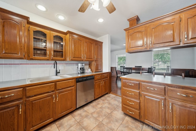 kitchen featuring ceiling fan, dishwasher, sink, backsplash, and light tile patterned floors