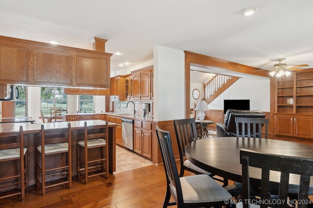 dining room featuring light hardwood / wood-style flooring, ceiling fan, and sink