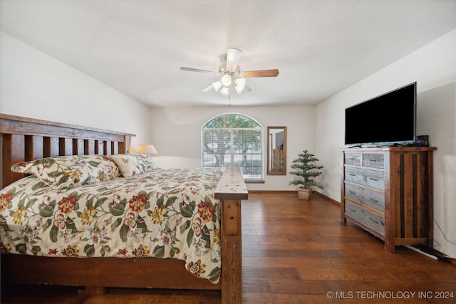 bedroom with dark hardwood / wood-style flooring and ceiling fan