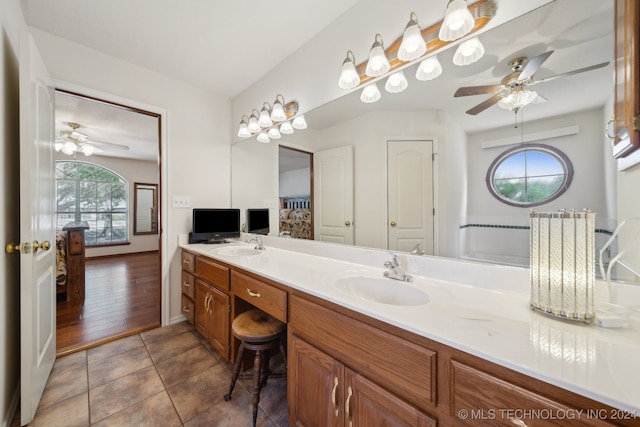 bathroom with tile patterned floors, vanity, and ceiling fan