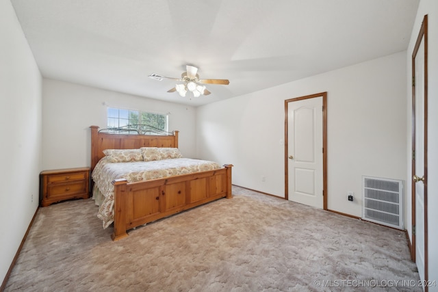 bedroom with ceiling fan and light carpet