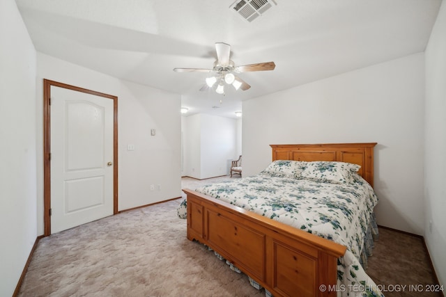 bedroom with ceiling fan and light carpet