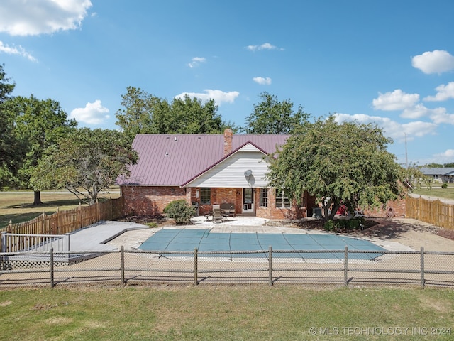 view of pool featuring a patio area and a yard