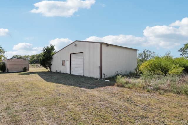 view of outbuilding with a lawn and a garage