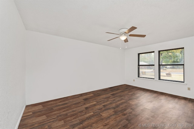 unfurnished room featuring a textured ceiling, ceiling fan, and dark hardwood / wood-style flooring