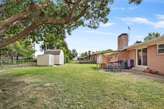 view of yard with a shed and a patio area