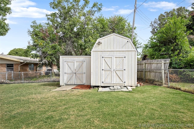 view of outdoor structure featuring a lawn