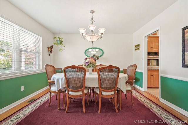 dining space featuring an inviting chandelier