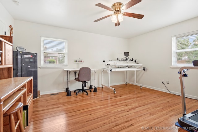 home office featuring light hardwood / wood-style floors and ceiling fan