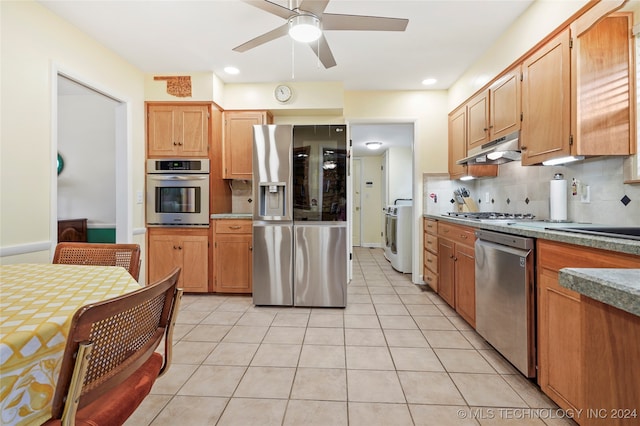 kitchen featuring backsplash, ceiling fan, appliances with stainless steel finishes, and light tile patterned flooring