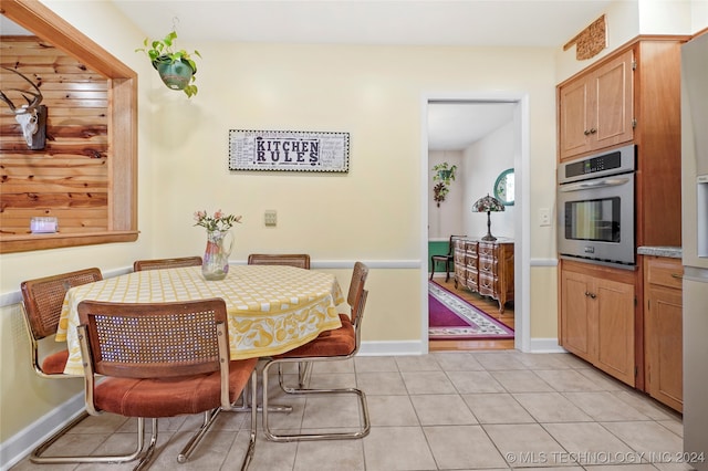 dining space featuring light tile patterned floors