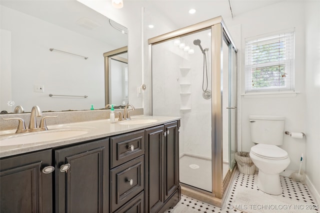 bathroom featuring walk in shower, vanity, toilet, and tile patterned floors