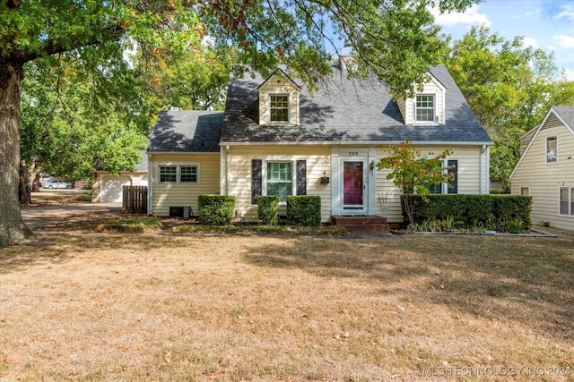 cape cod house featuring a front yard