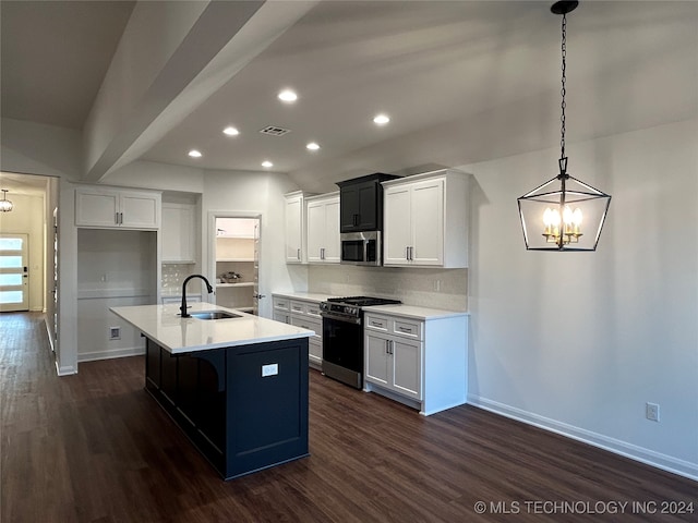 kitchen featuring stainless steel appliances, sink, a kitchen island with sink, and dark hardwood / wood-style flooring