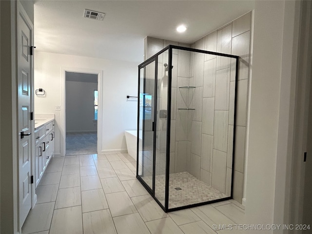 bathroom with independent shower and bath and vanity