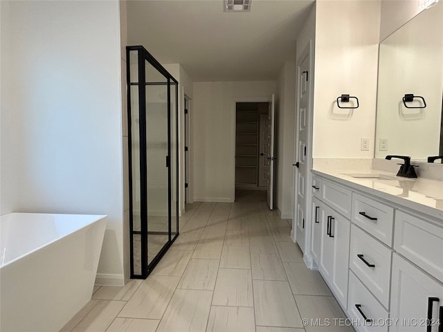 bathroom featuring independent shower and bath and vanity