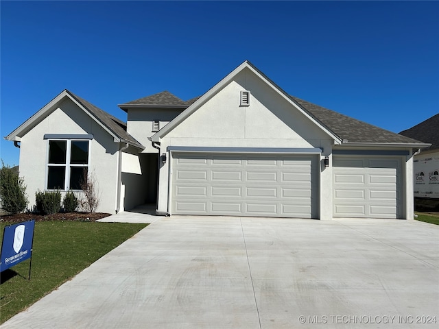 view of front of property with a front lawn and a garage